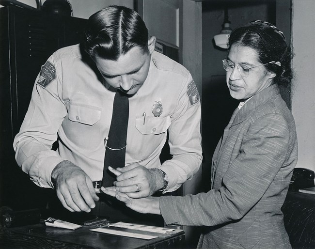 Rosa Parks being fingerprinted by Deputy Sheriff D.H. Lackey after being arrested on February 22, 1956, during the Montgomery bus boycott. 