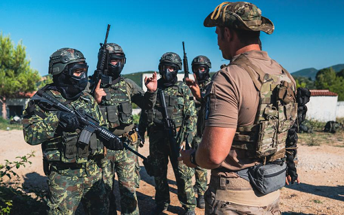 A U.S. Army Green Beret  prepares Albanian special forces for drills July 23, 2021, (Devin Andrews/U.S. Marine Corps)