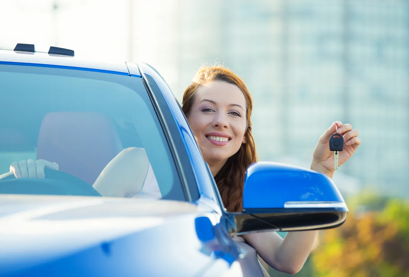 LAdy holding key out of window of a car