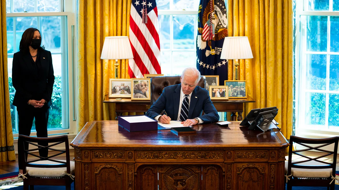 President Biden Signing Stimulus checks with Vice President Kamala Harris standing to left side