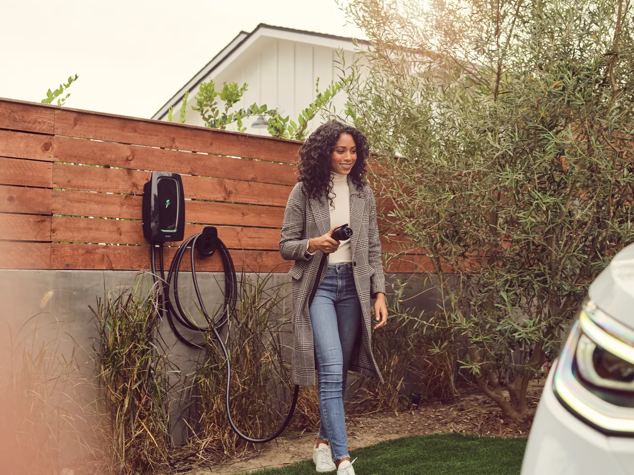 Woman holding an electric car charger