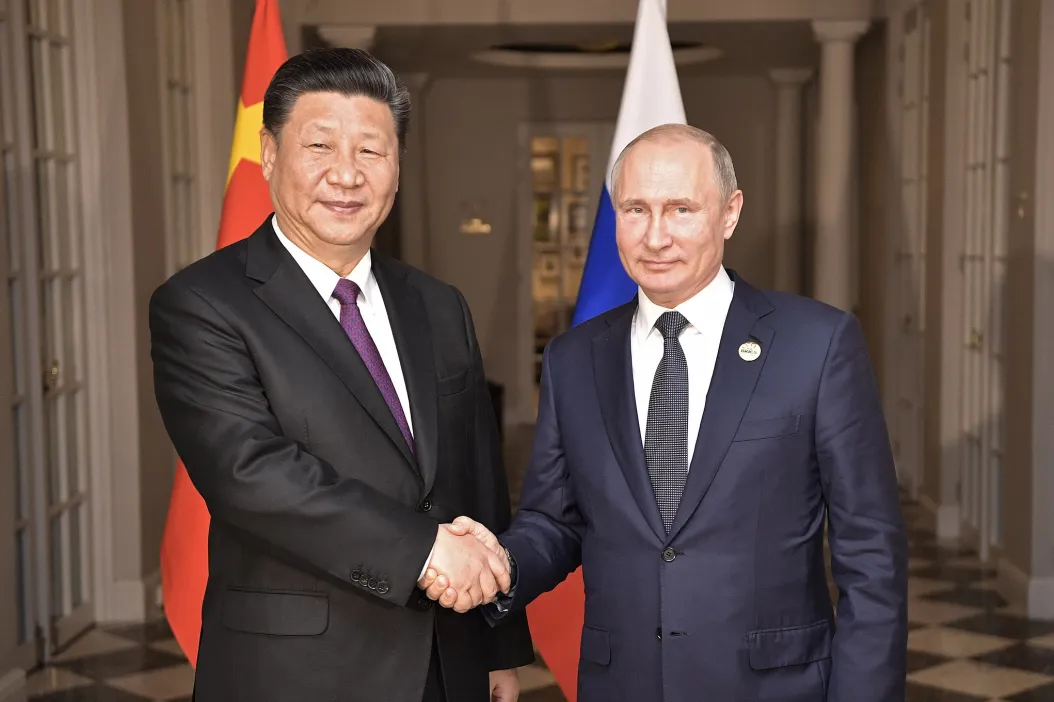 Chinese President Xi Jinping (Left) shaking hands with Russian President Vladimir Putin (Right)