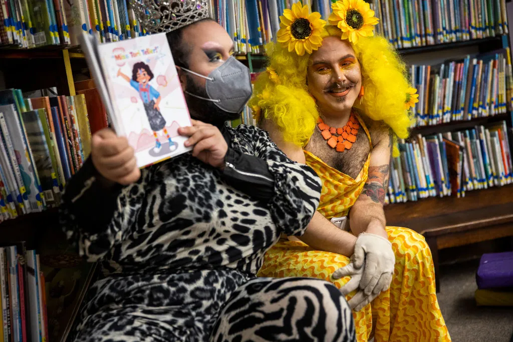 Chelsea, MA - June 25: Drag queens Just JP, left, and Sham Payne read stories to children during a Drag Story Hour