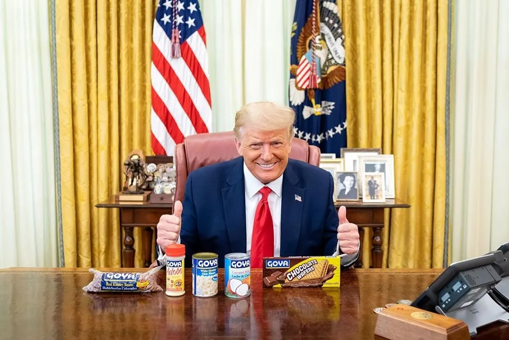 Former president Donald Trump thumbs up, goya products on desk