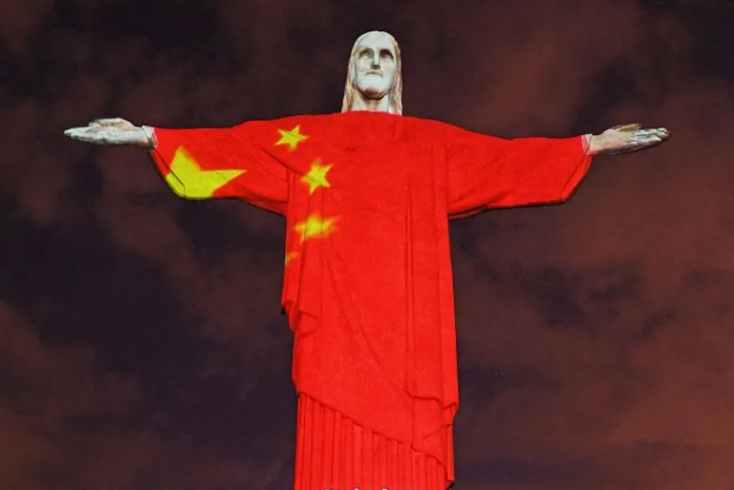 View of the world famous Christ the Redeemer statue on Easter day with a Chinese flag projected on it