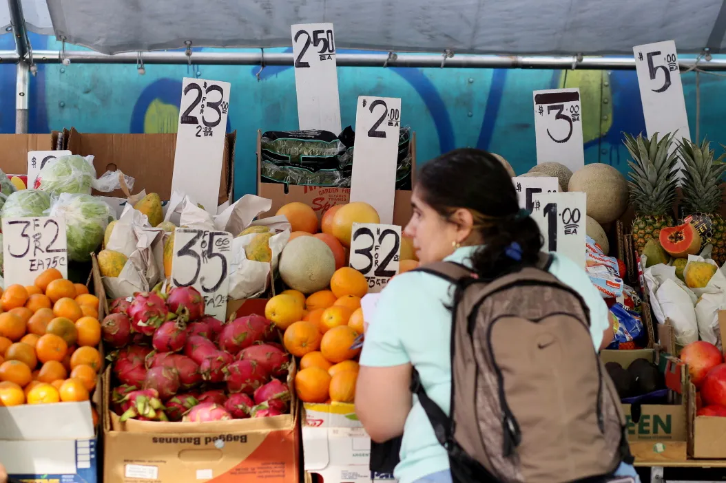 A woman picks food in a fresh market on July 26, 2022 in New York.